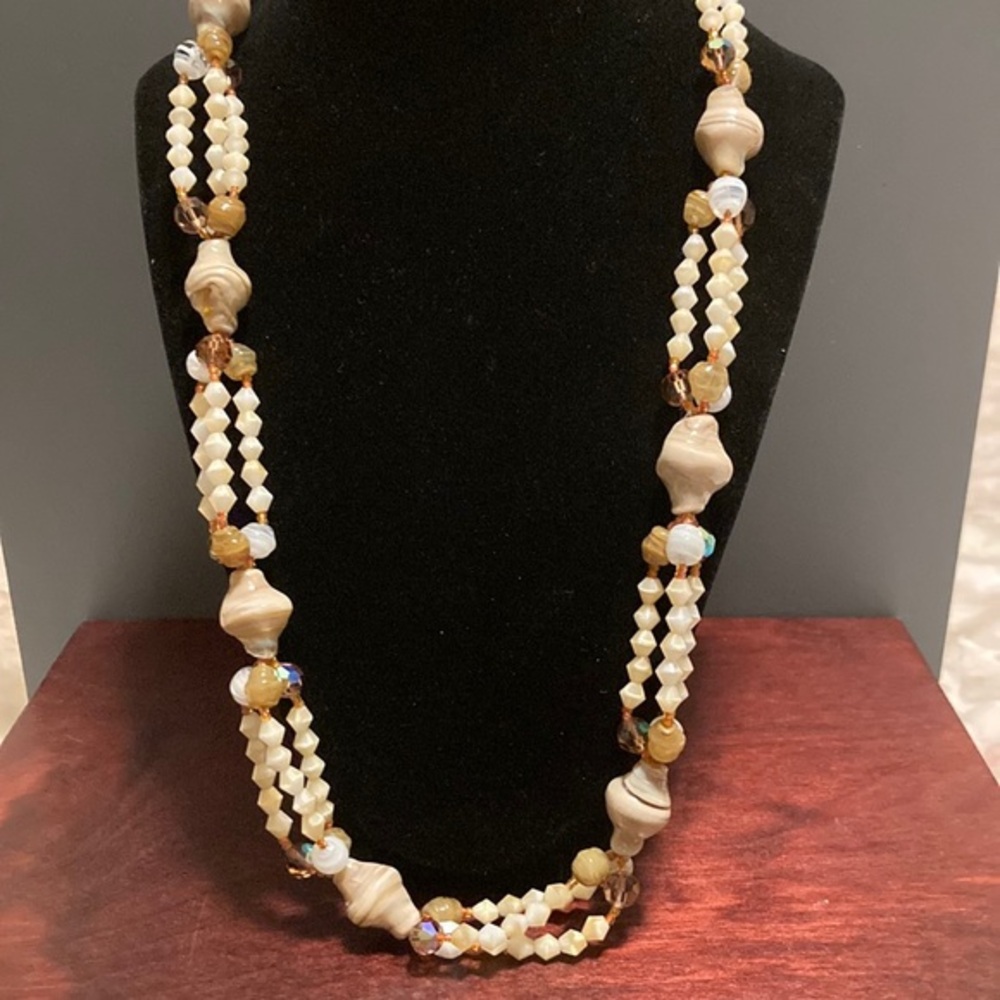 Layered beaded necklace featuring glass shells